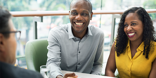 Couple meeting with mortgage loan originator.