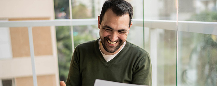 Man looking at his finances over breakfast.