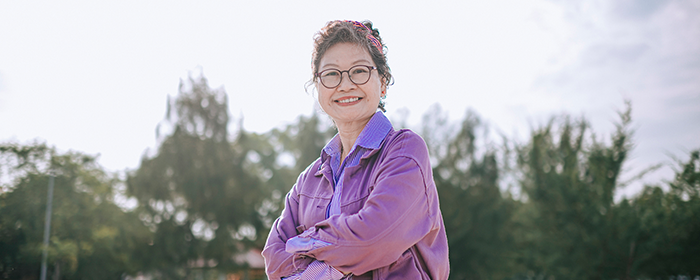 Senior woman standing confidently.