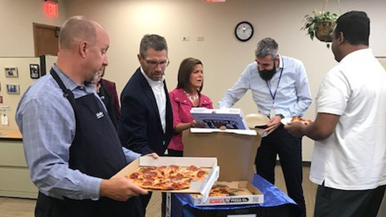 Senior leadership conducting the Pizza with Purpose events