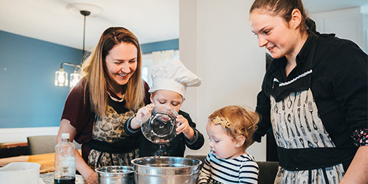mom baking in the kitchen with their kids