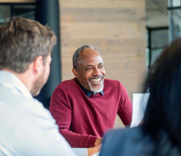 man smiling while talking
