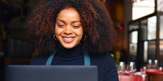 woman at work smiling at her computer