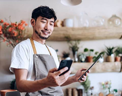 man using his phone and tablet