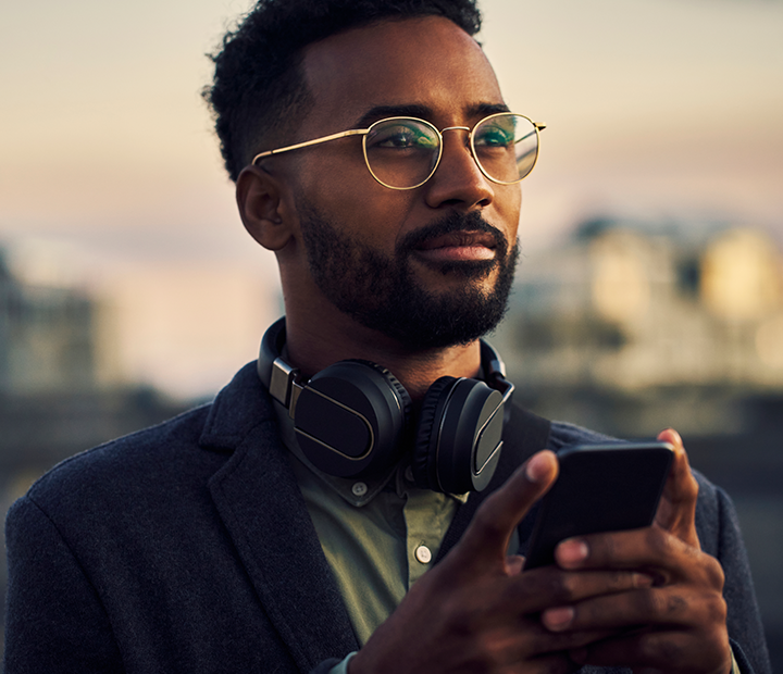 man using his phone at sunset