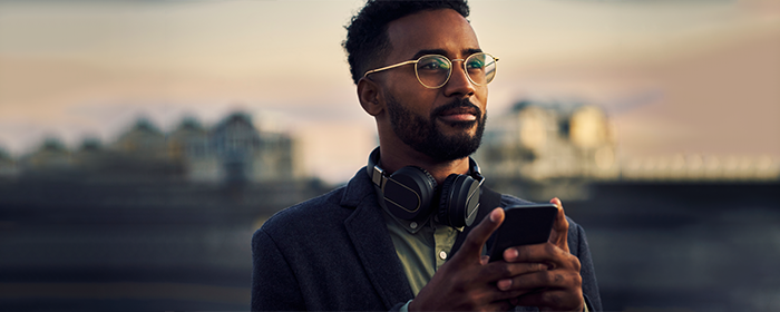 man using his phone at sunset