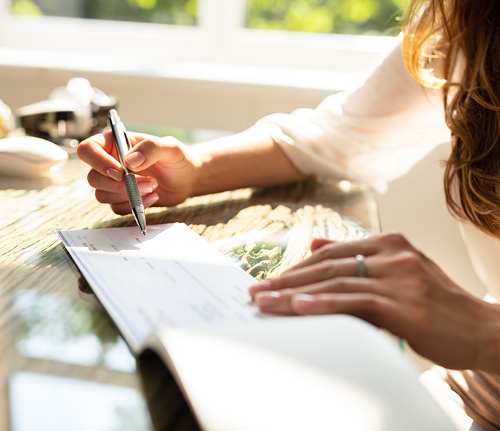 woman writing a check