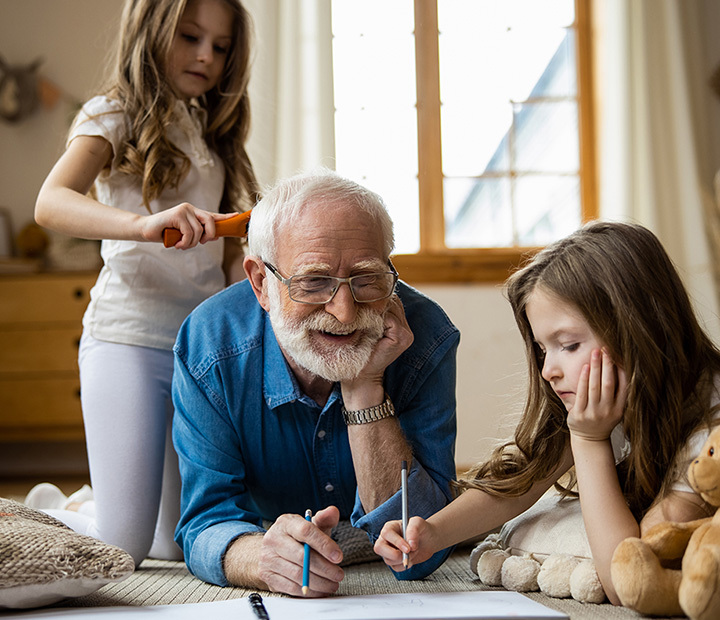man playing with his grand-daughters