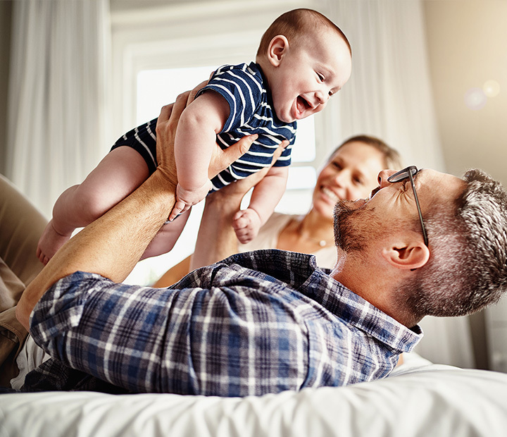 father holding baby