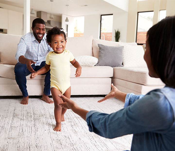 baby walking from dad to mom