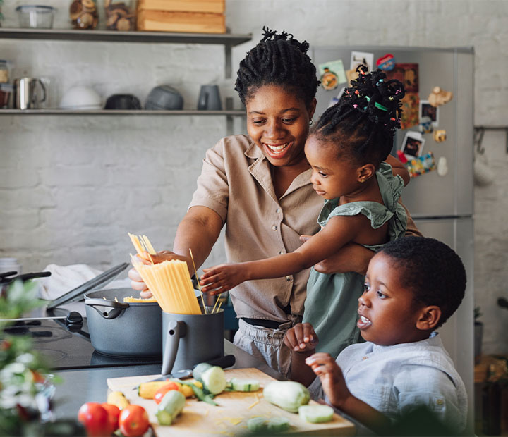 mom cooking with her two kids