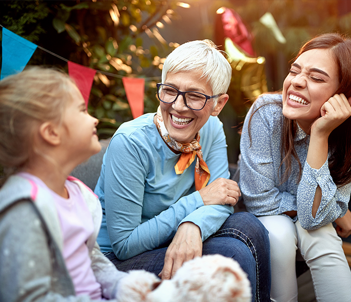 woman with her daughter and mother at a party