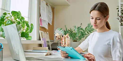 Young woman reading about 5 factors that affect credit score