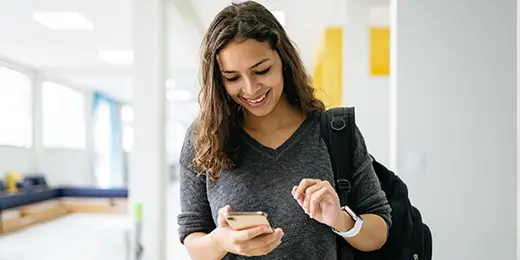 young woman checking her credit score on mobile phone