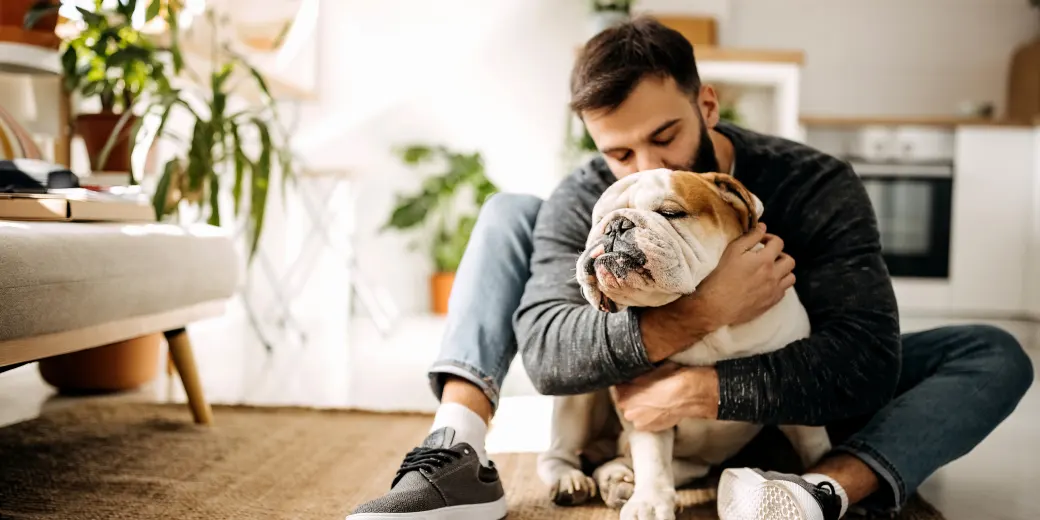 Man hugging bulldog