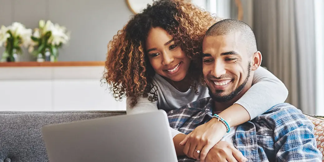Young couple hugging on sofa