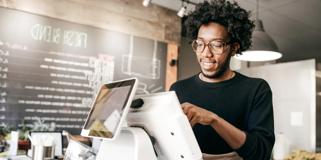 Young man at point-of-sale terminal